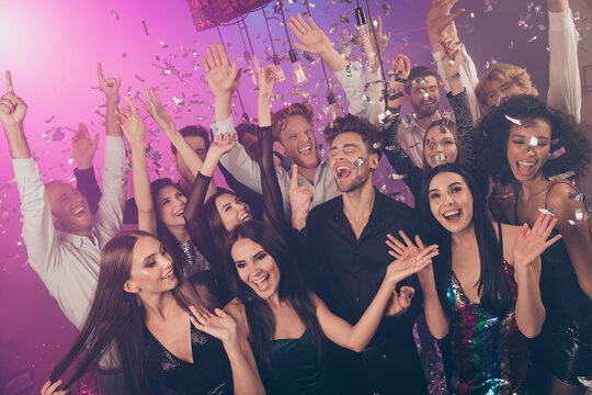 Photo of group crazy people raise hands catch falling sequins confetti wear stylish outfit modern club indoors