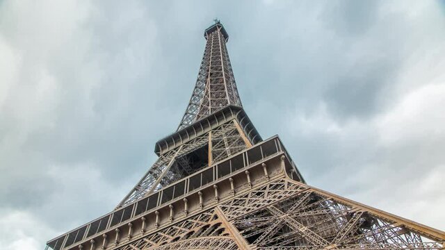 Eiffel Tower Hips timelapse - Shot from the base of the Eiffel Tower, cloudy sky on the background Paris, France