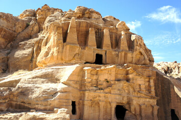 An ancient temple carved in yellow desert stone on a summer day. Old City Petra Jordan