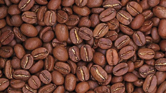 Spinning roasted Arabica coffee beans background