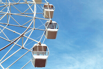 Ferris wheel in an amusement Park against a blue sky