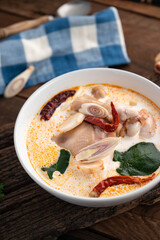 Tom kha kai or tom kha gai, traditional Thai food soup chicken on wood