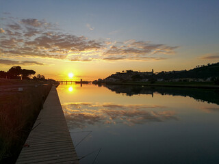 Italy Tuscany Castiglione della Pescaia, sunset reflected on the waters of the Bruna river
