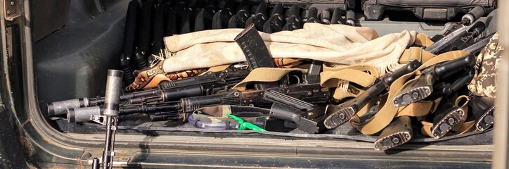Lasertag or laser war tag equipment weapon in the trunk of the car. Guns, rifles and head band...