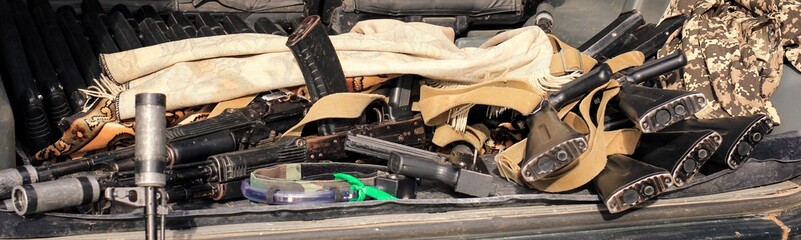 Lasertag or laser war tag equipment weapon in the trunk of the car. Guns, rifles and head band...