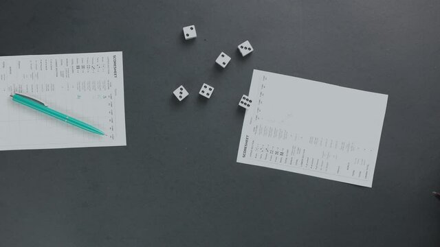 Overhead shot of two friends playing Yahtzee