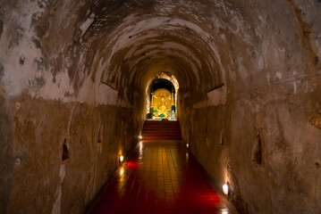 Wat Umong Suan Puthatham is a Buddhist temple in the historic centre, Buddha statue in the old cave of Wat Umong in Chiang Mai, Thailand.