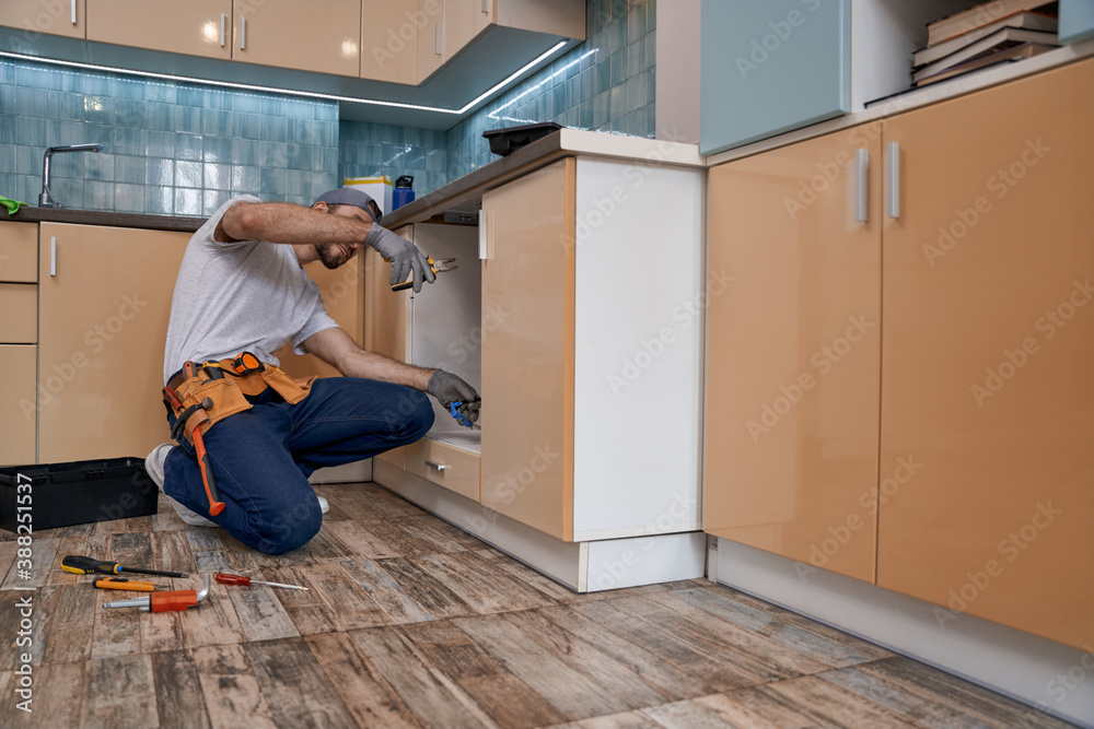 Wall mural Young caucasian man working with instrument and wires