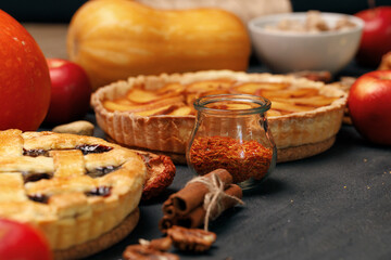 Tart pie and pumpkin on dark black surface
