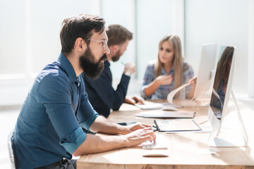 Fototapeta premium businessman and a group of employees working in the office.