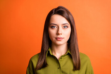 Photo of charming young business lady look camera clam face wear green shirt isolated orange color background