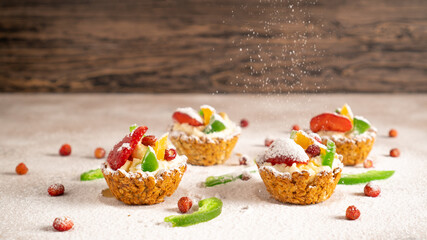 New Year's sweet screensaver Healthy cupcakes with cottage cheese, strawberries, banana, dried fruits and powdered sugar