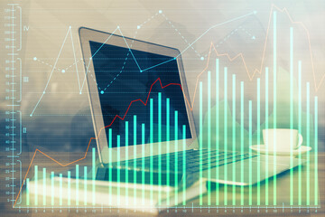 Double exposure of chart and financial info and work space with computer background. Concept of international online trading.