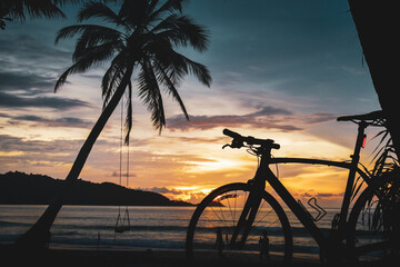 silhouette of a bicycle on sunset at Patong Beach, Phuket, Thailand