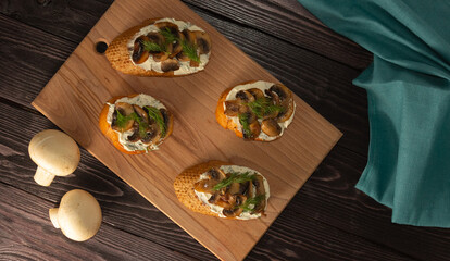 Bruschetta with mushrooms. Sandwiches with soft cheese, mushrooms and dill. The view from the top. Healthy delicious Breakfast, Italian cuisine.