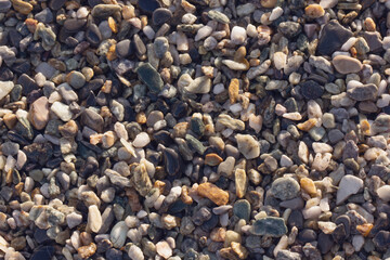 Abstract nature pebbles background. Wet pebbles texture.