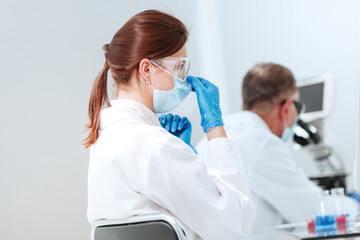 close up. female scientist sitting at a laboratory table.