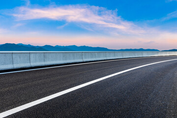 Fototapeta premium Asphalt viaduct road and beautiful sky cloud at sunrise.