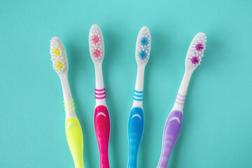 Toothbrushes for all family on blue background.