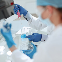 close up. scientists examining liquid samples in the lab.