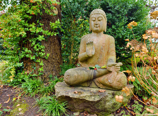 Buddah statue in a garden in autumn season