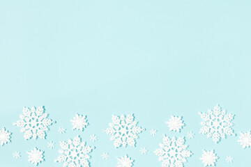 Fototapeta na wymiar Christmas or winter composition. Pattern made of snowflakes on pastel blue background. Christmas, winter, new year concept. Flat lay, top view, copy space