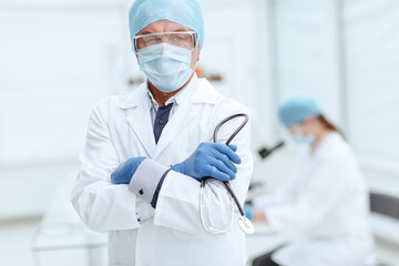 Fototapeta premium practicing doctor with a stethoscope in his hands on the background of the laboratory.