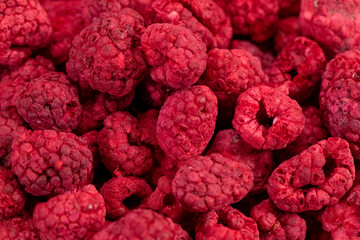 Macro shot of freeze dried organic raspberries, fruit snack, ingredient for smoothies, sauces,...