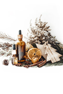 Bottle with organic oil on festive Christmas background with orange, cinnamon, anise. Photo