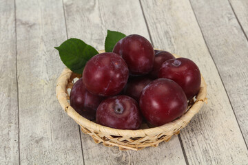 Plum heap in the wooden basket