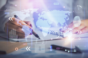 Multi exposure of hands making notes with world map hologram and data theme icons. Concept of global data.