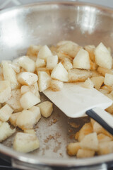 Process of frying banana and apple filling in a pan.