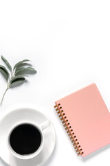 Pink notepad, cup of coffee and olive branch. Home office background with space for your text . Flat lay, top view. Educational concept.