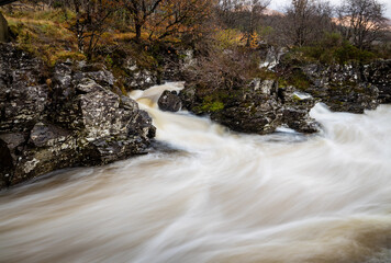 long exposure shot of the waterfalls in glen orchy near bridge of orchy in the argyll region of the highlands of scotland during autumn