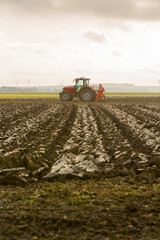 Fototapeta premium Tractor plowing the rich soil of the land