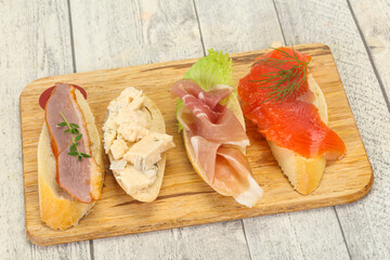 Tapas - bruschetta with prosciutto, salmon, duck and gorgonzola