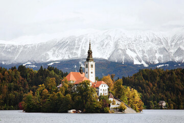 Scenic View of the snow-capped Alps mountain peaks against the backdrop of lake Bled.