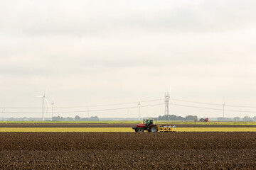 Tractor plowing the rich soil of the land