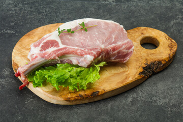 Raw pork bone steak over wooden