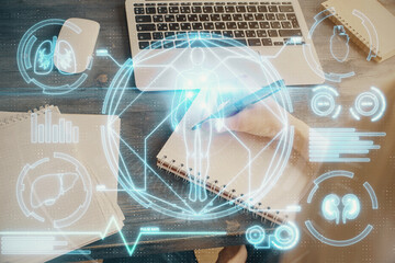 Education theme hologram over woman's hands writing background. Concept of study. Double exposure