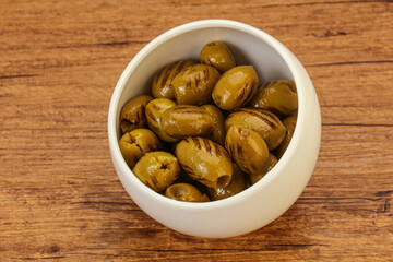 Green grilled olives in the bowl