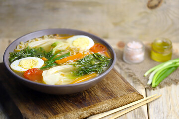 Appetizing Chinese noodle soup with bok choi cabbage. Chinese cuisine.