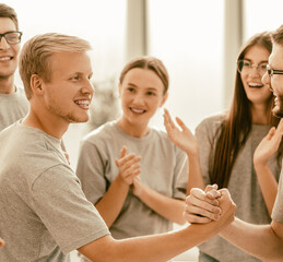 group of cheerful students applauding rivals during the training