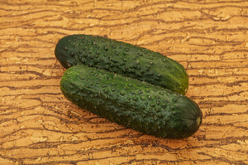 Green fresh cucumbers over background
