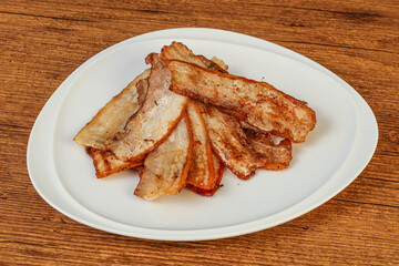 Roasted juicy bacon in the plate