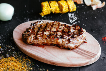 Grilled pork steak on a wooden board