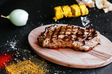 Grilled pork steak on a wooden board