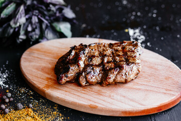 Grilled pork steak on a wooden board