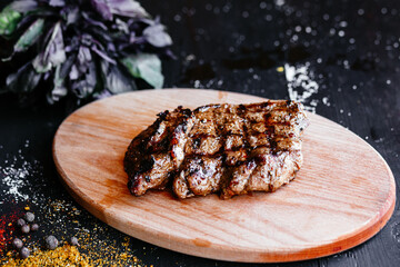 Grilled pork steak on a wooden board
