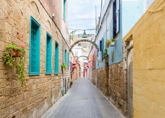 Small alleyway with colorful houses, Christian quarter in the Mediterranean coastal town Tyre, Lebanon